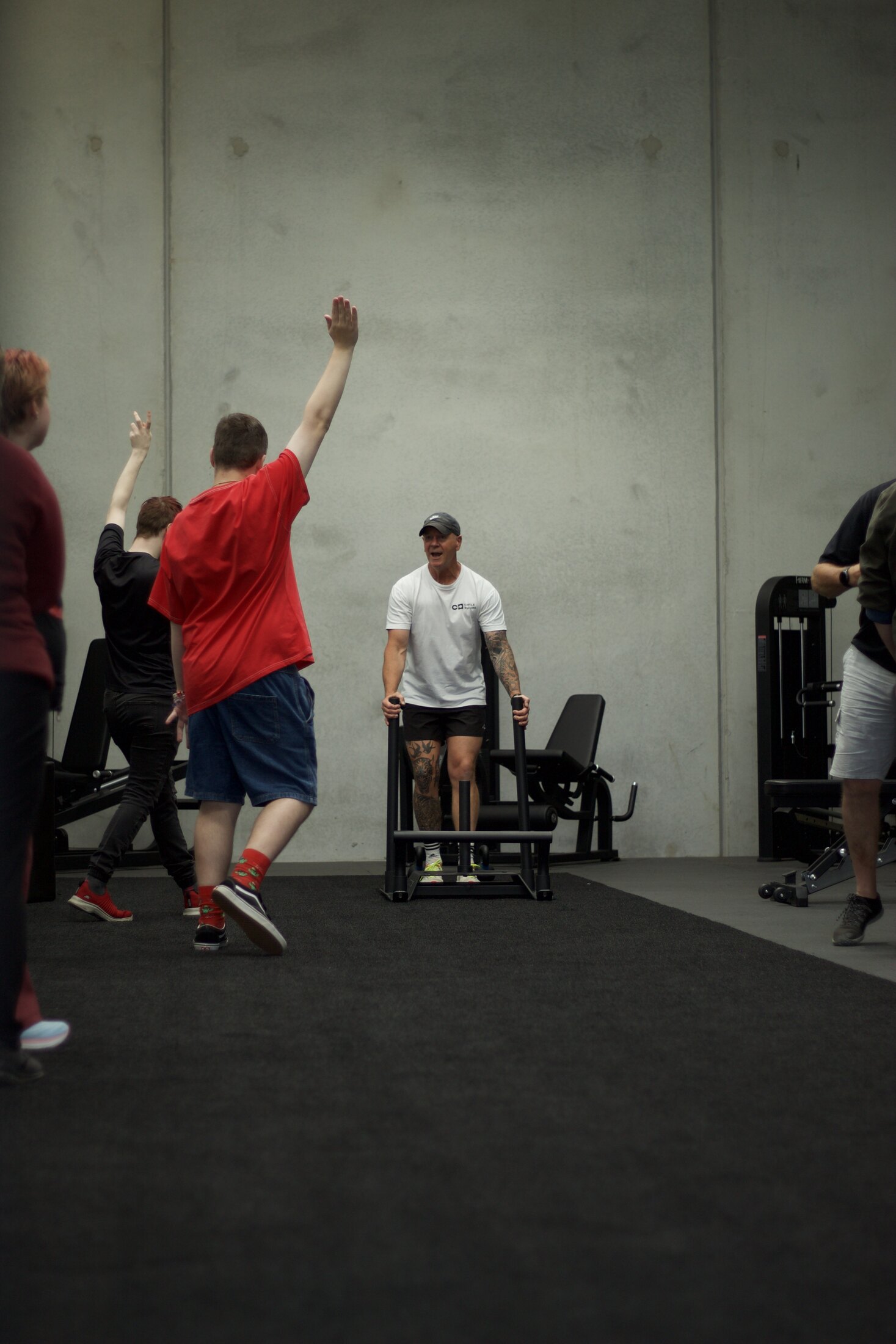 A participant raises an arm in celebration during a session