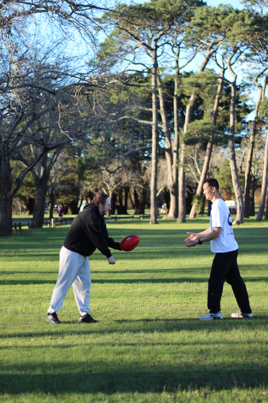 Handballing a footy back and forth in the park